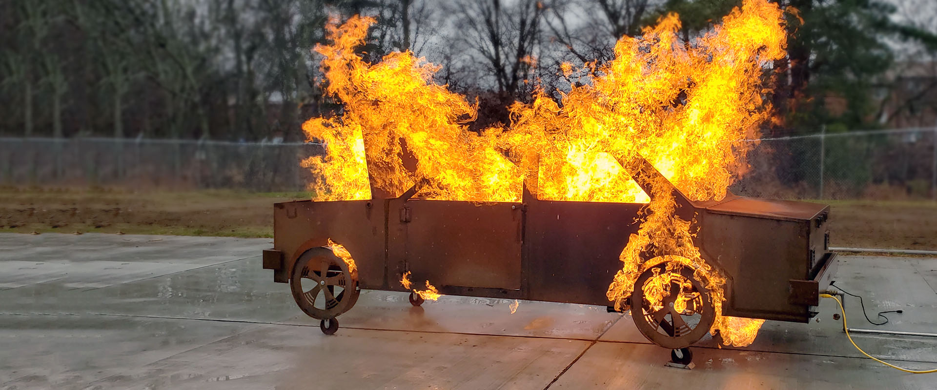 Firefighter training system for controlled automobile fire response and extinguishment