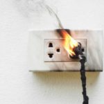 A wall outlet catches fire.