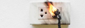 A wall outlet catches fire.