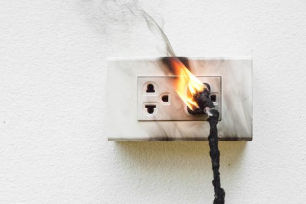 A wall outlet catches fire.