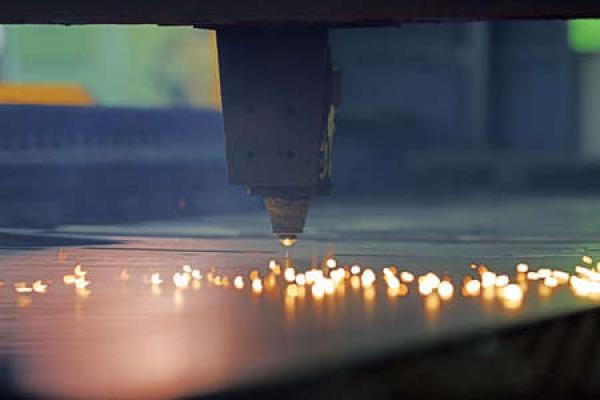 A close up view of a machine engaging in fiber laser cutting
