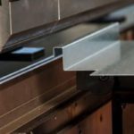 A press brake machine bends a piece of sheet metal