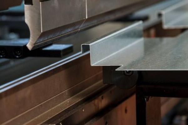 A press brake machine bends a piece of sheet metal