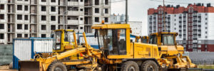 A road grader pushing dirt at a construction site