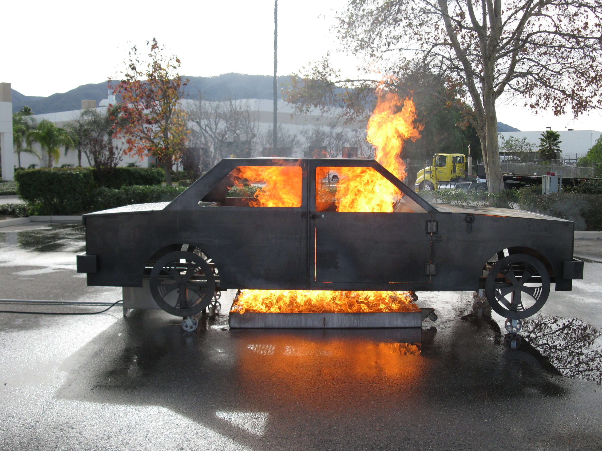 Vehicle live-fire training prop simulating a controlled car fire